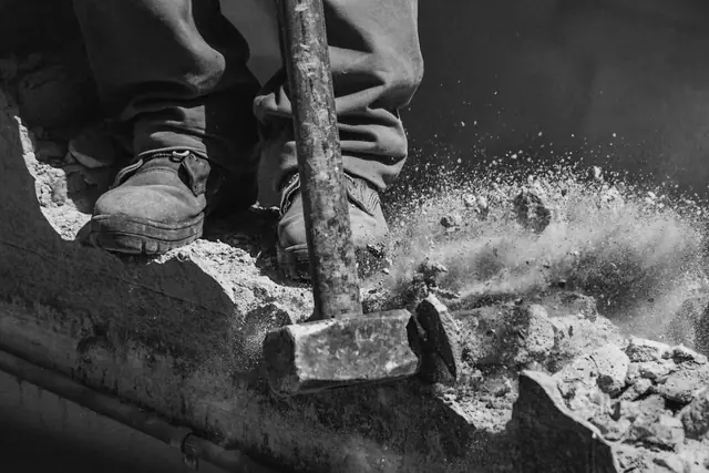 Sledgehammer breaking up an old concrete slab