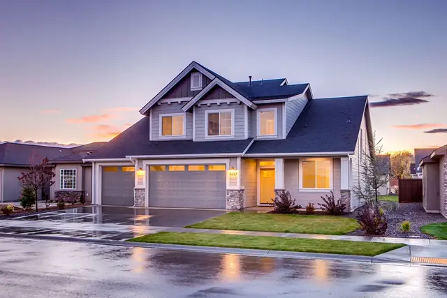 Concrete driveway in front of a house at dusk