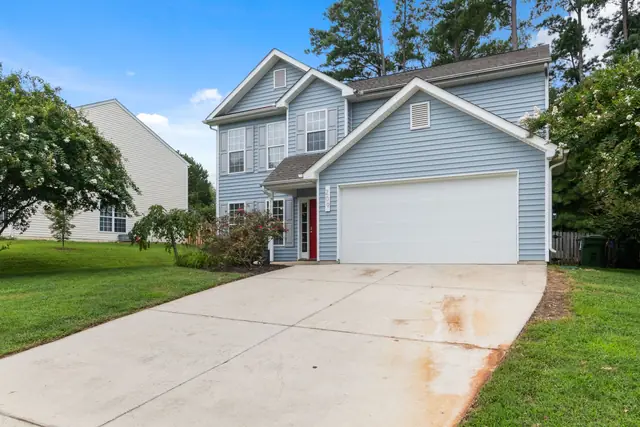 Concrete driveway leading up to a two-car garage