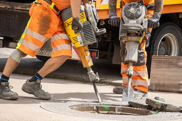 Crew using jackhammers to cut out old concrete