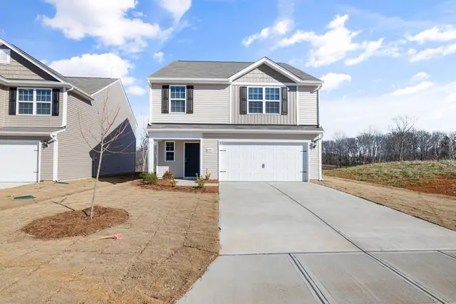 Wide new concrete driveway in front of a two-story house