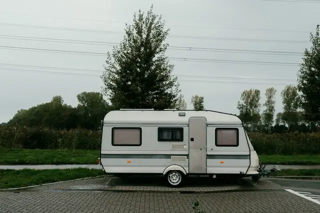 Camper trailer parked on a paved pad